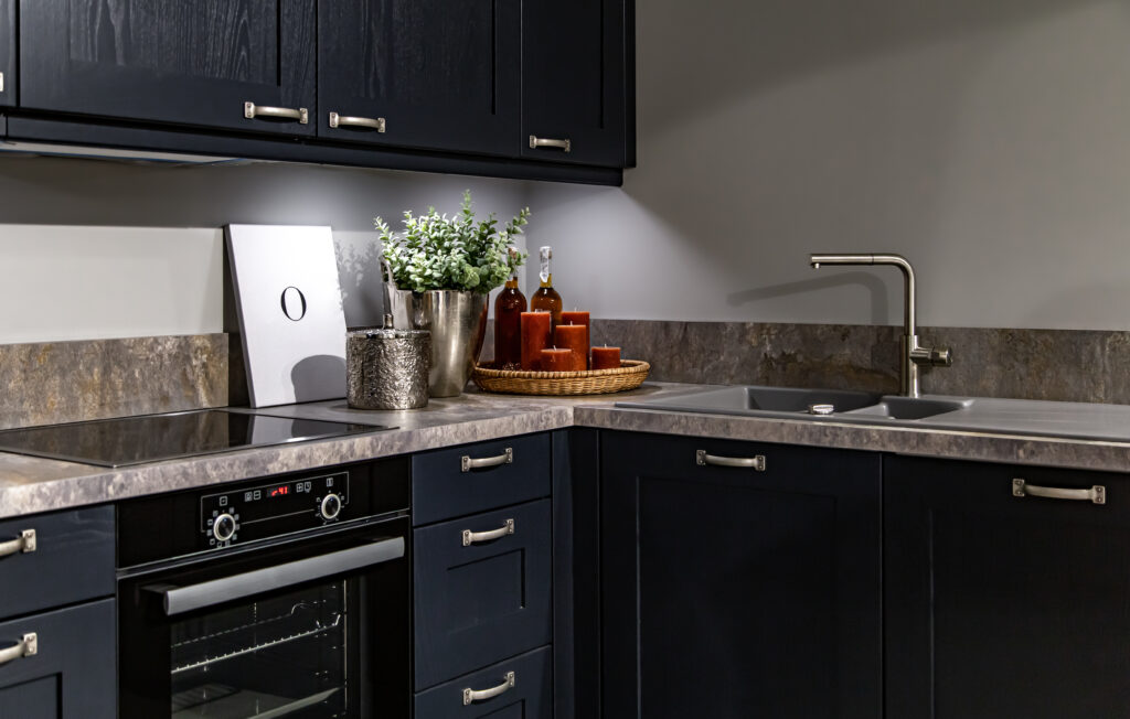 L-shaped modular kitchen design with ample storage and stylish backsplash