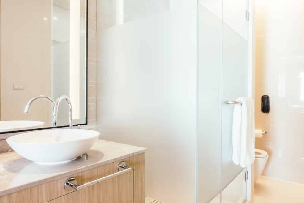 Small bathroom design featuring vertical storage and glass shower enclosure