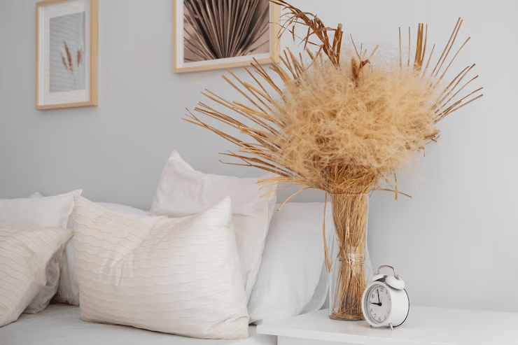 Stylish bedroom showcasing a blend of boho and minimal wall decor with soft lighting, layered textiles, and modern art accents.
