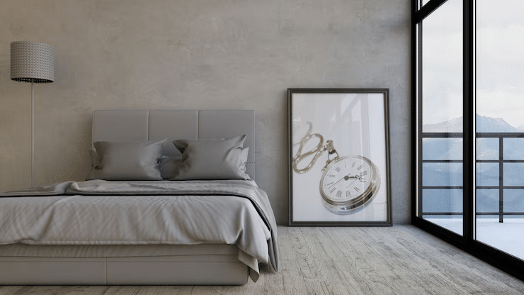 Minimalist bedroom wall with abstract painting and soft grey tones.