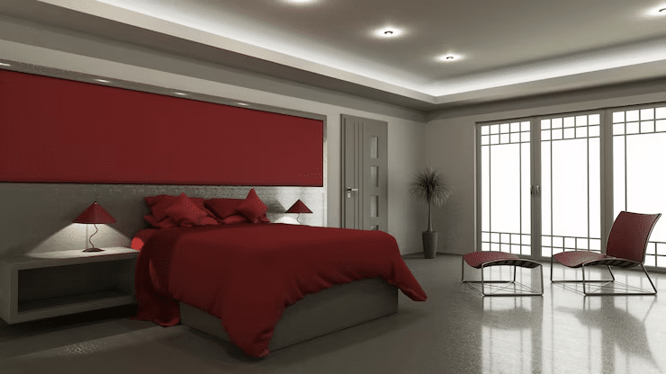 Modern glam bedroom wall with dark feature color and gold accents.