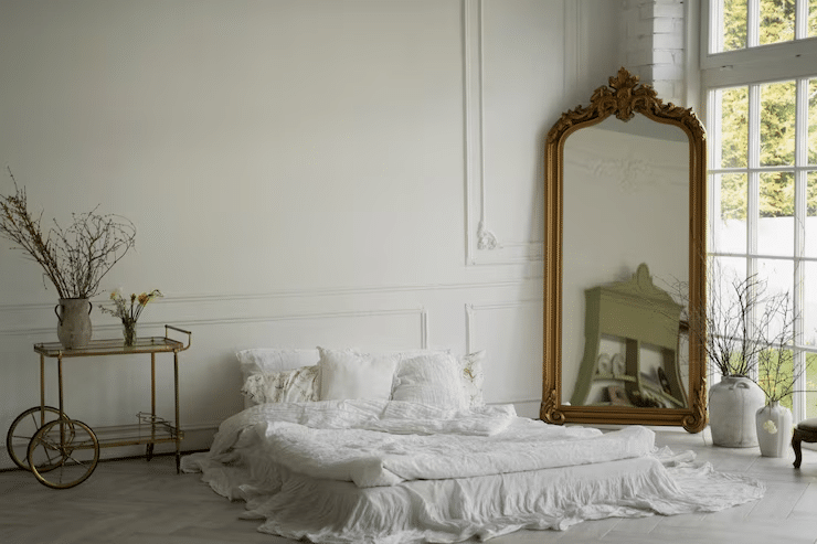 Large wall mirror beside window in light-filled 2BHK bedroom