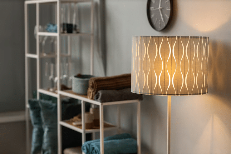 Warm wall-mounted lights in 2BHK bedroom with soft decor theme