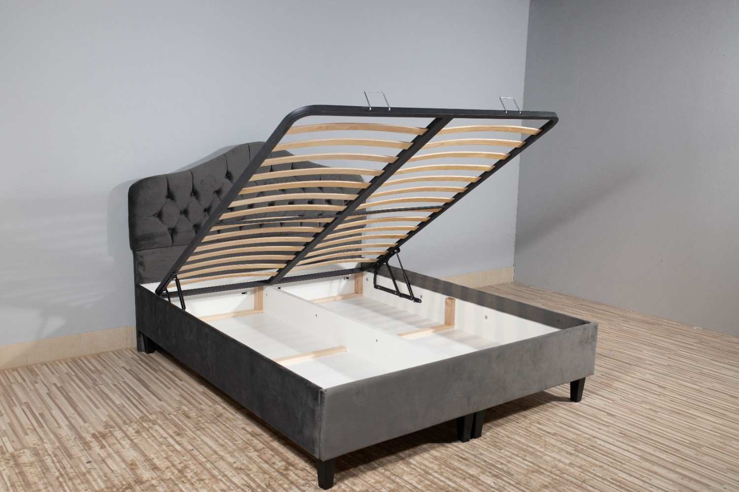 Custom storage bed with hydraulic lift system designed for small bedrooms in Bengaluru by Elegante Interiors