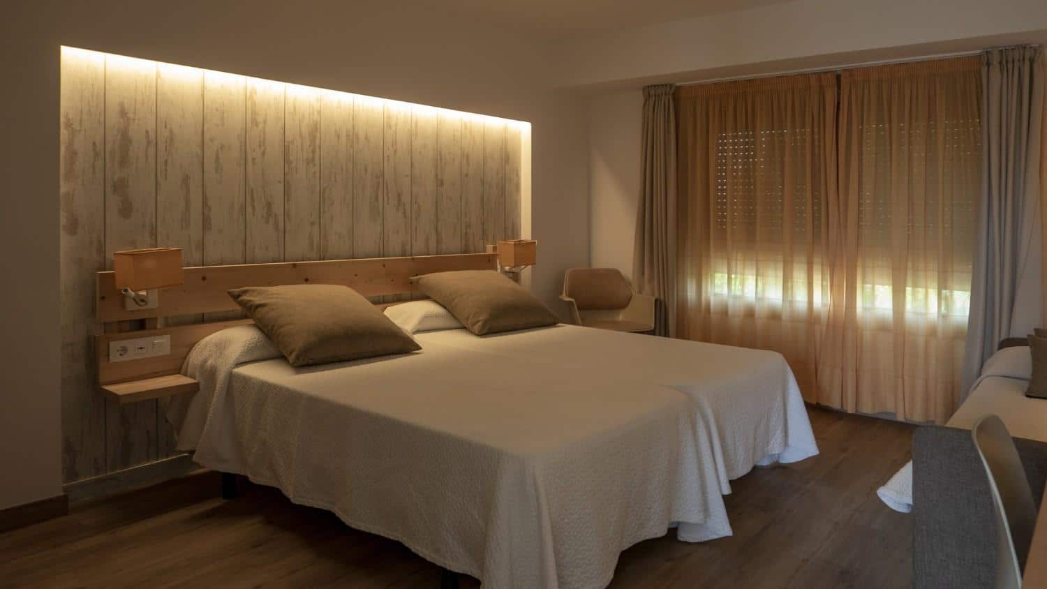 Layered lighting design in compact Bengaluru bedroom featuring ambient, task, and accent lighting by Elegante Interiors