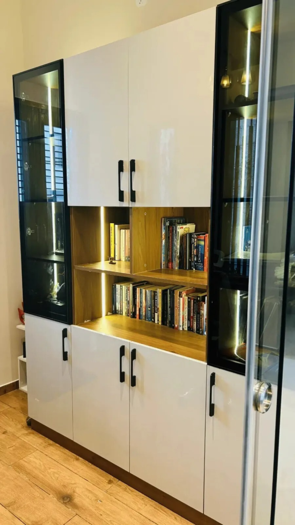 Sophisticated built-in storage unit with display shelving and integrated LED lighting by Elegante Interiors