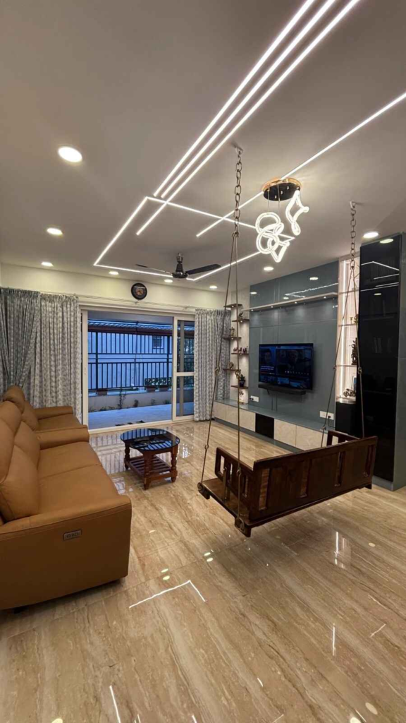 Elegant living room interior design with modern furniture, linear ceiling lighting and open layout in Bangalore luxury apartment by Elegante Interiors