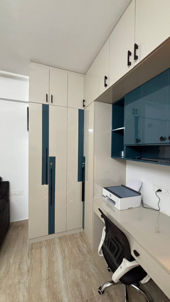 Luxury bedroom interior design Bangalore featuring custom wardrobes and integrated study area by Elegante Interiors