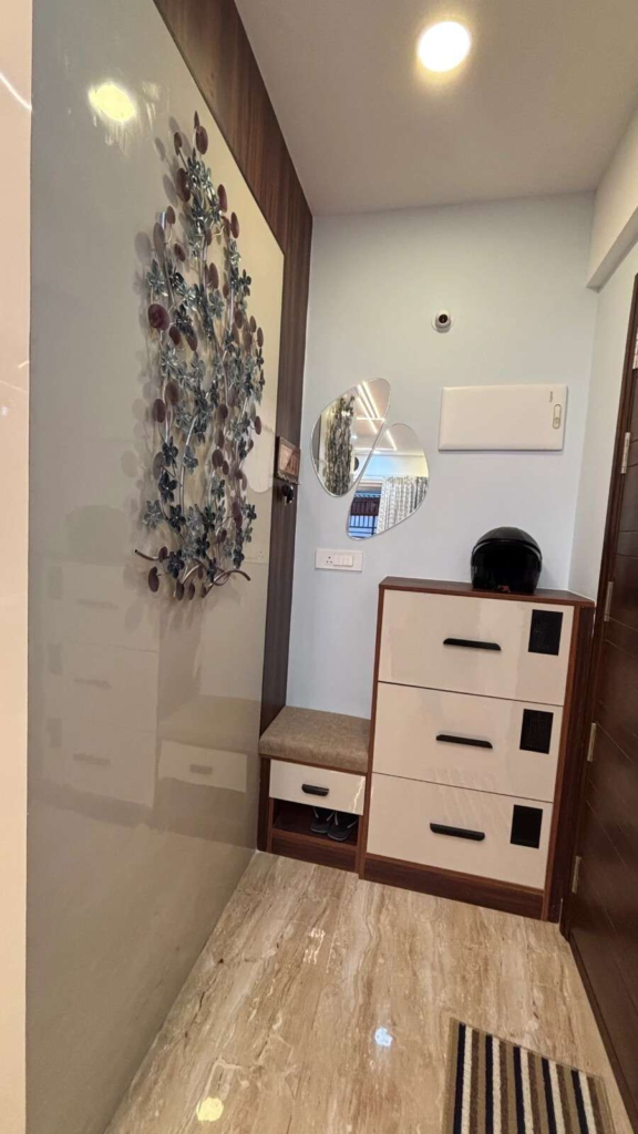 Custom storage solutions and entry area design in Bangalore luxury apartment by Elegante Interiors