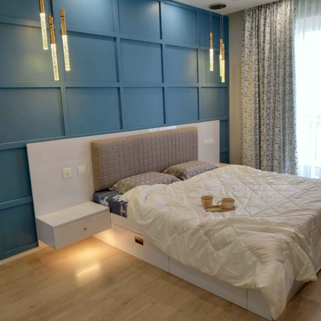 Modern master bedroom interior design with quilted headboard and pendant lighting - Elegante Interiors