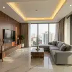 Home interior design in Bangalore — luxury living room with cove ceiling, Makrana marble flooring and custom teak veneer TV unit by Elegante Interiors